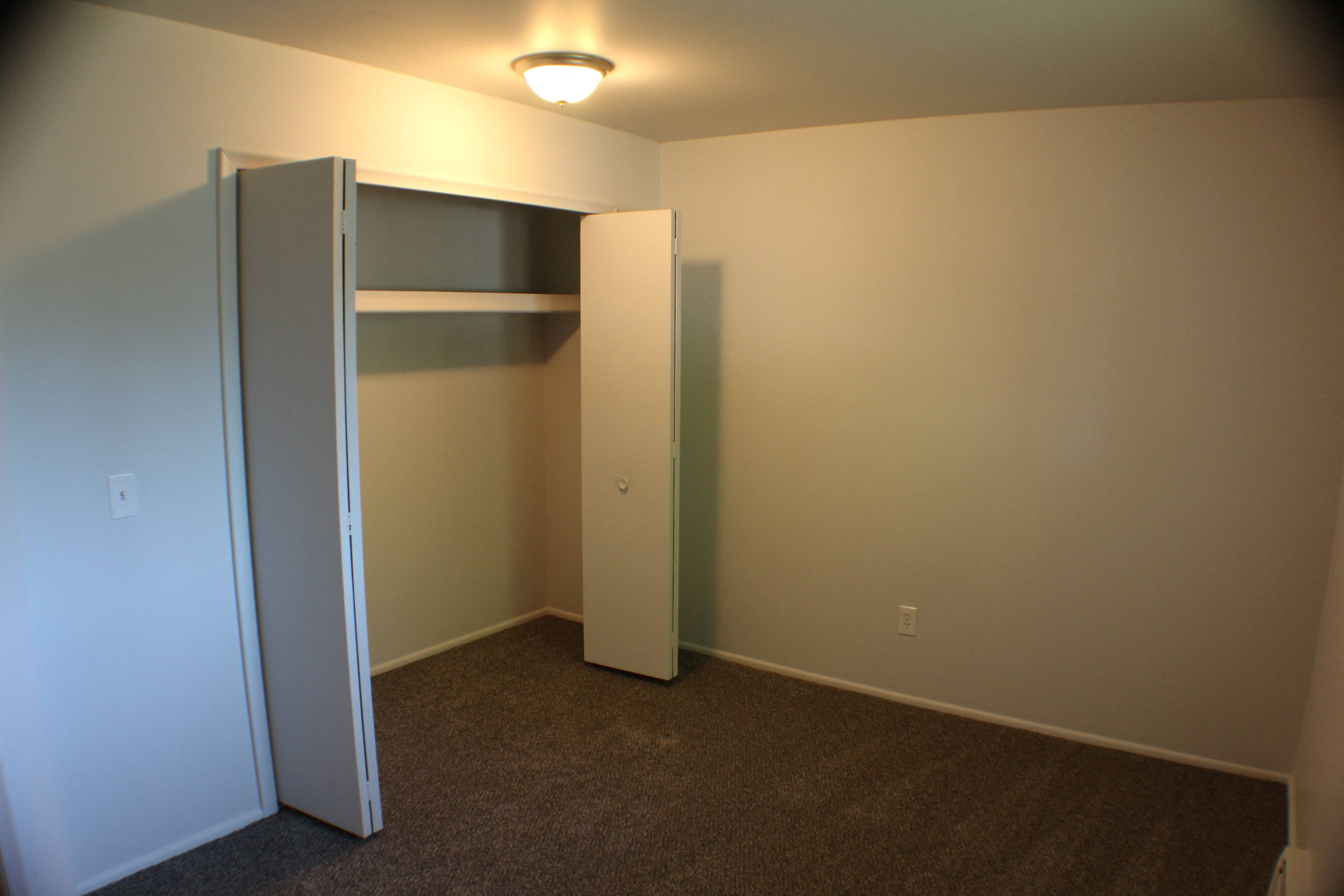 a room with a closet and a light on the ceiling